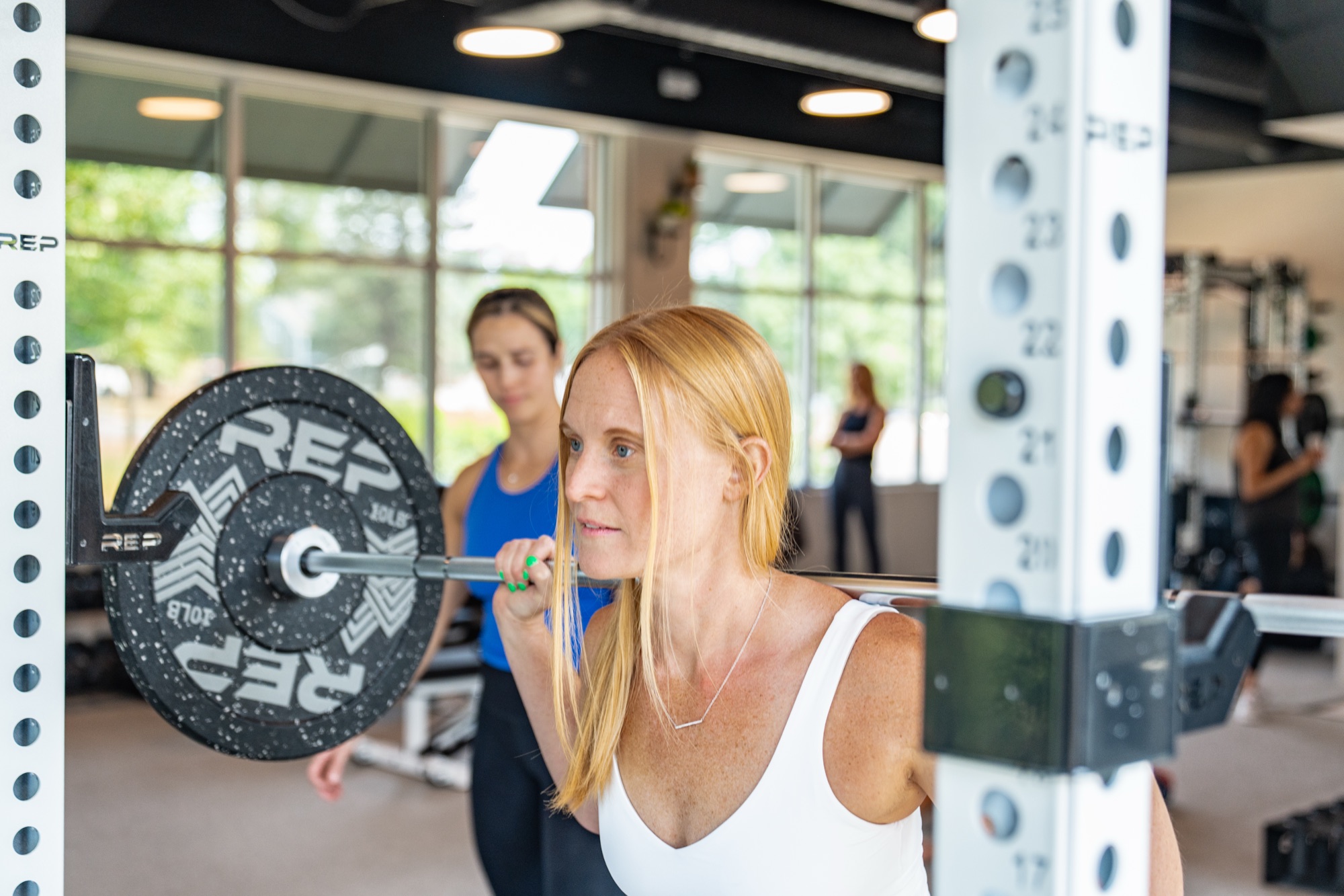 Women strength training with coach at Well&Studio